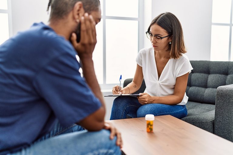 Man and woman having psychology session prescribing pills at psy